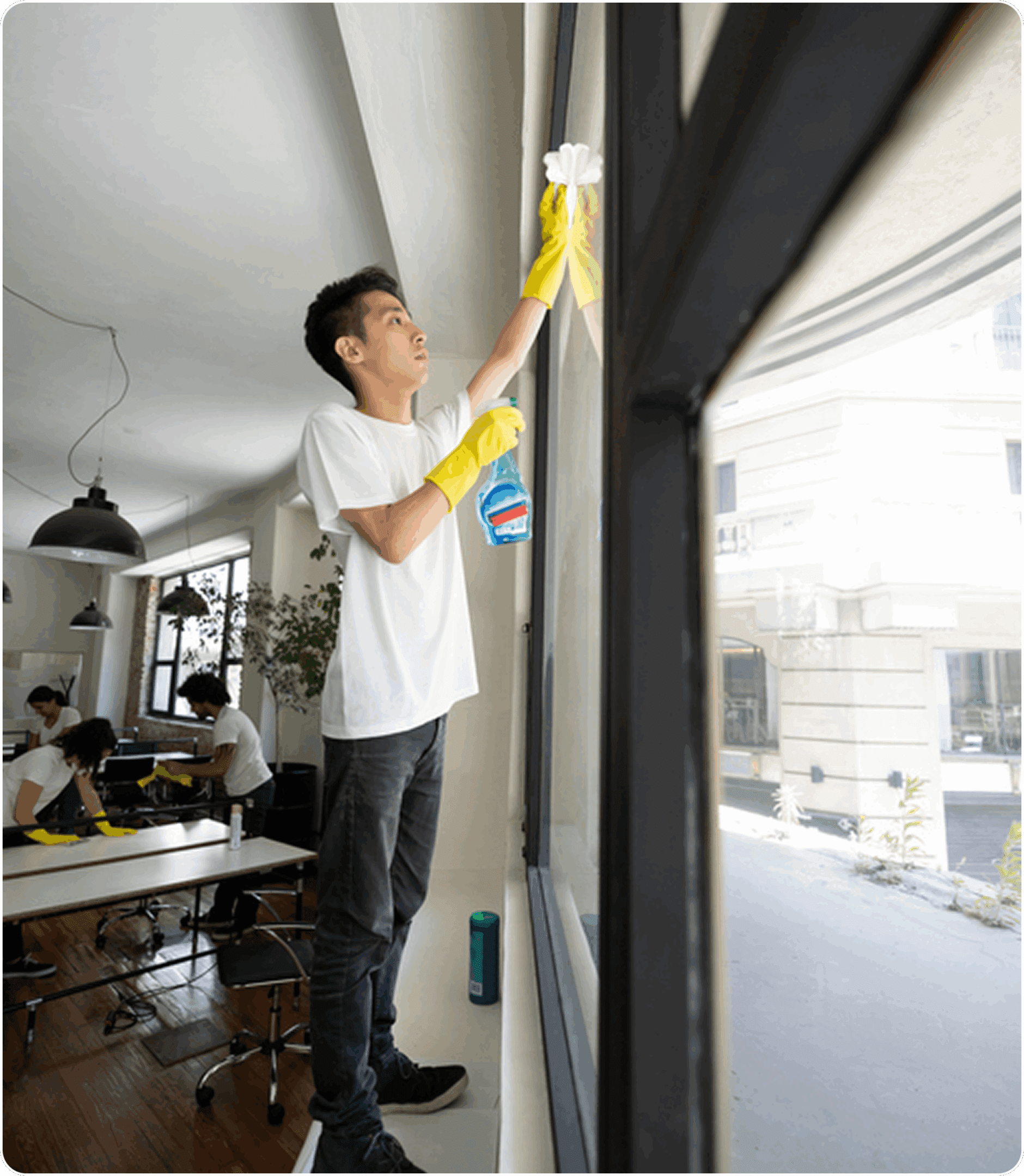 Man wearing gloves cleans large window