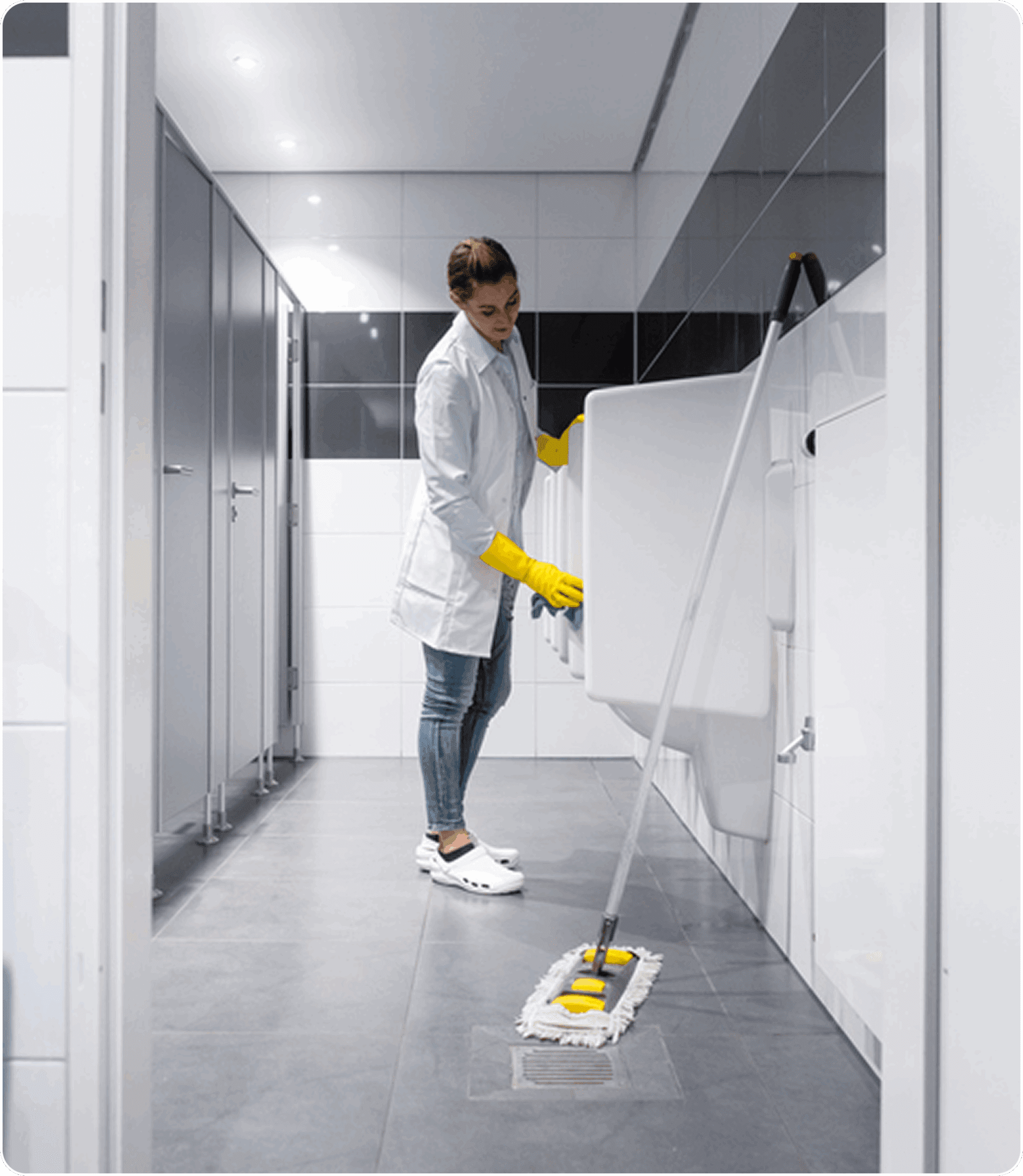 Worker maintaining cleanliness in restroom