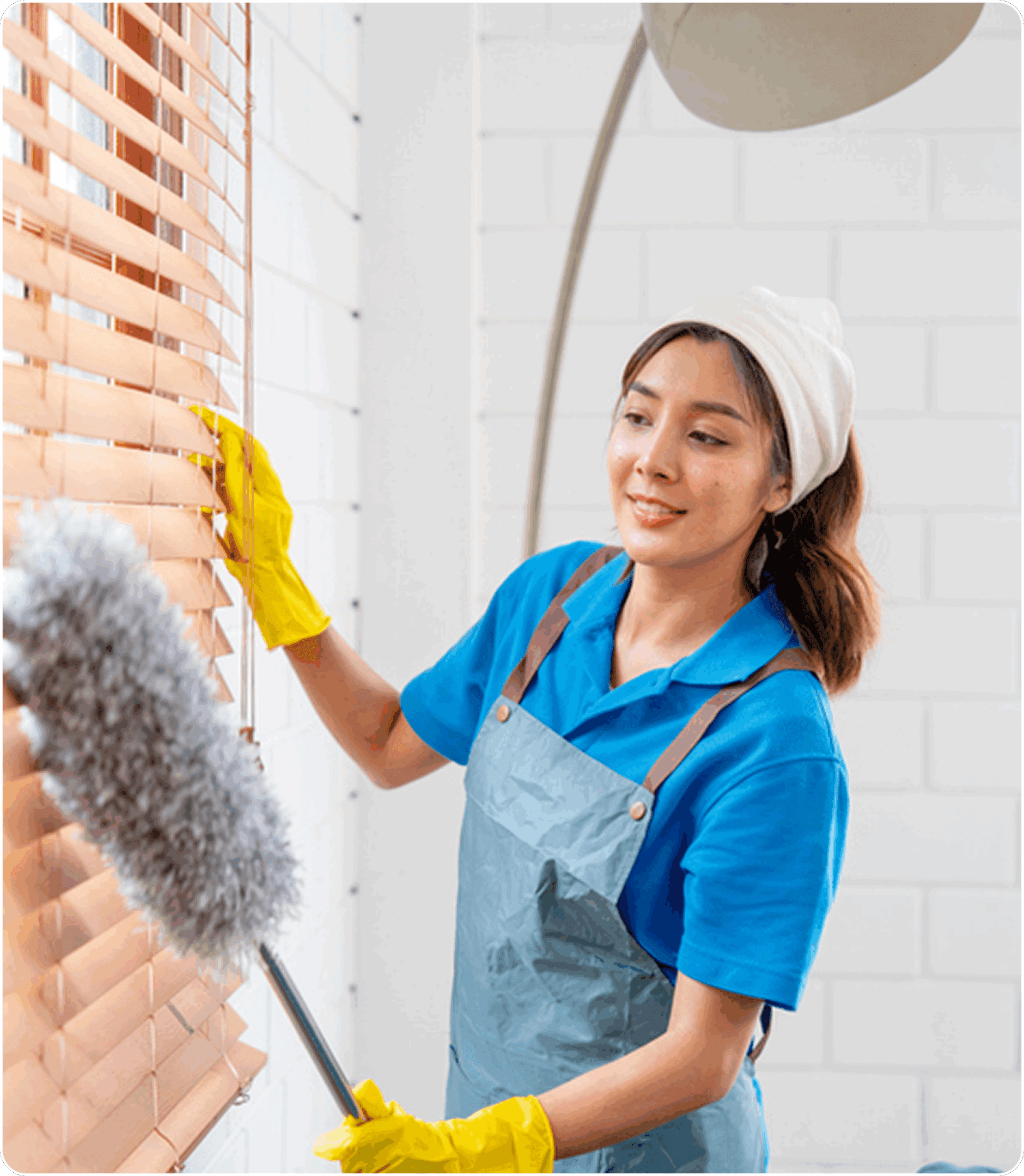 Woman dusting window blinds with duster