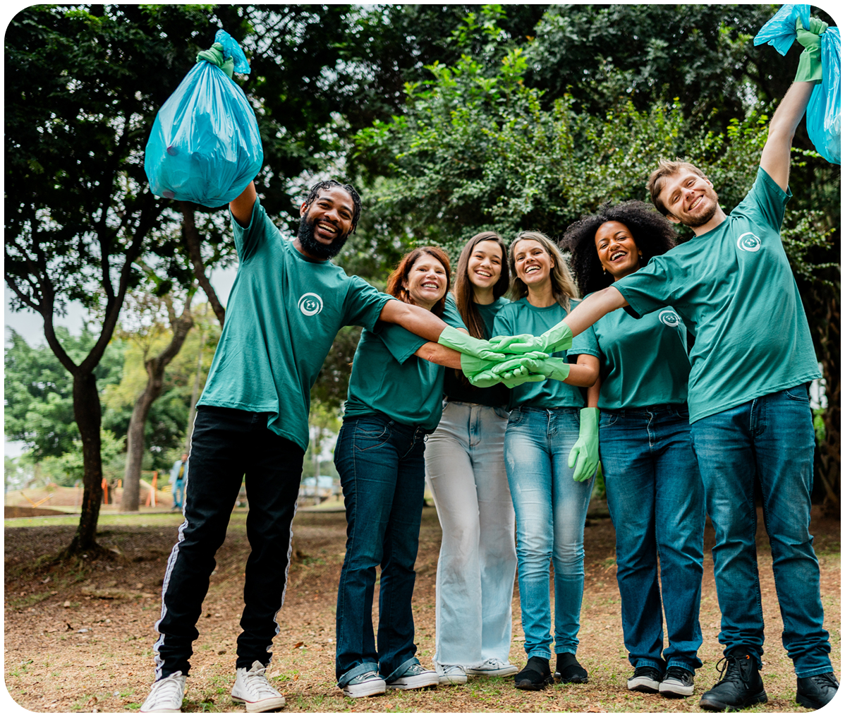 Group volunteering outdoors, holding trash bags.
