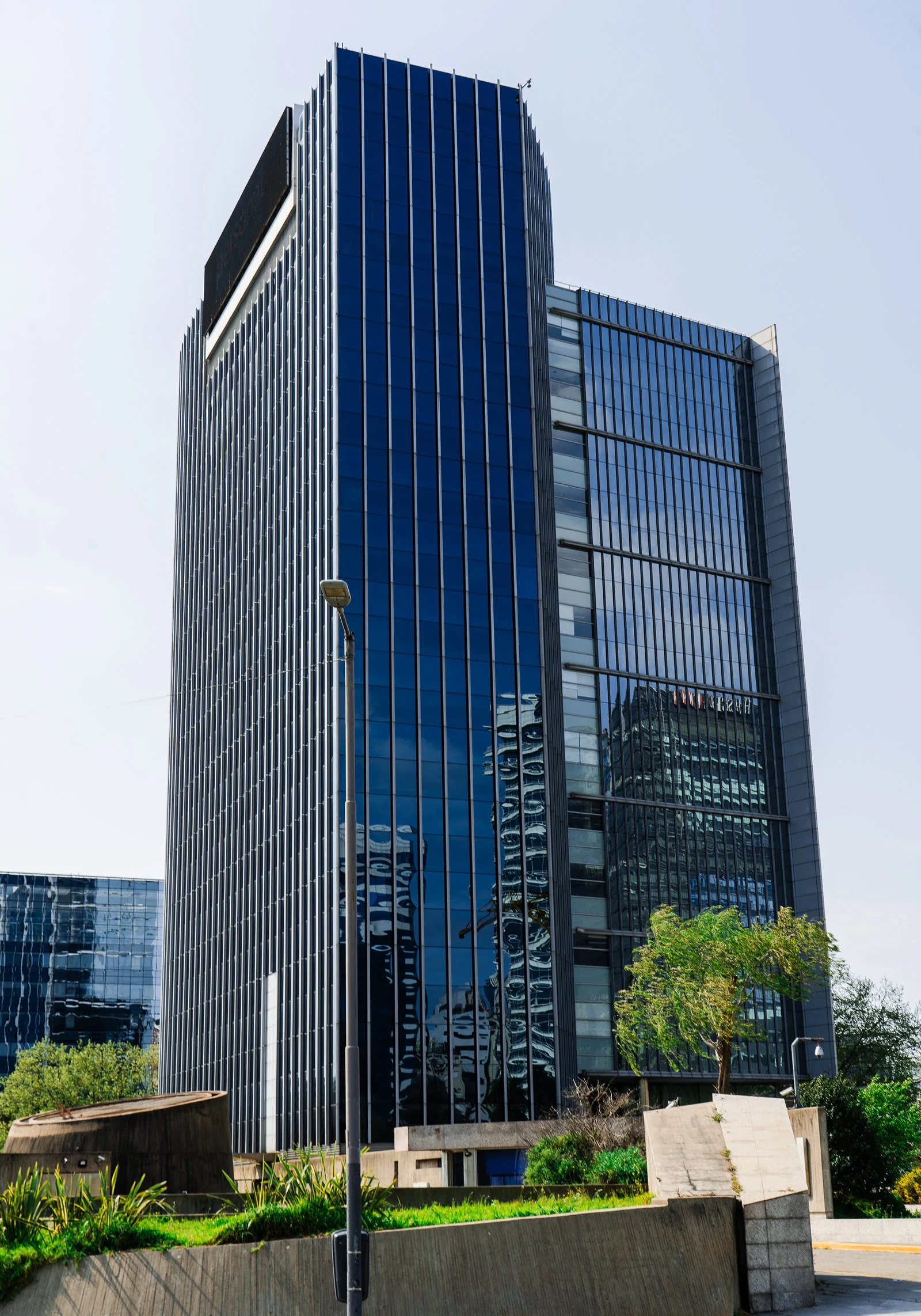 Modern glass office building with reflections.