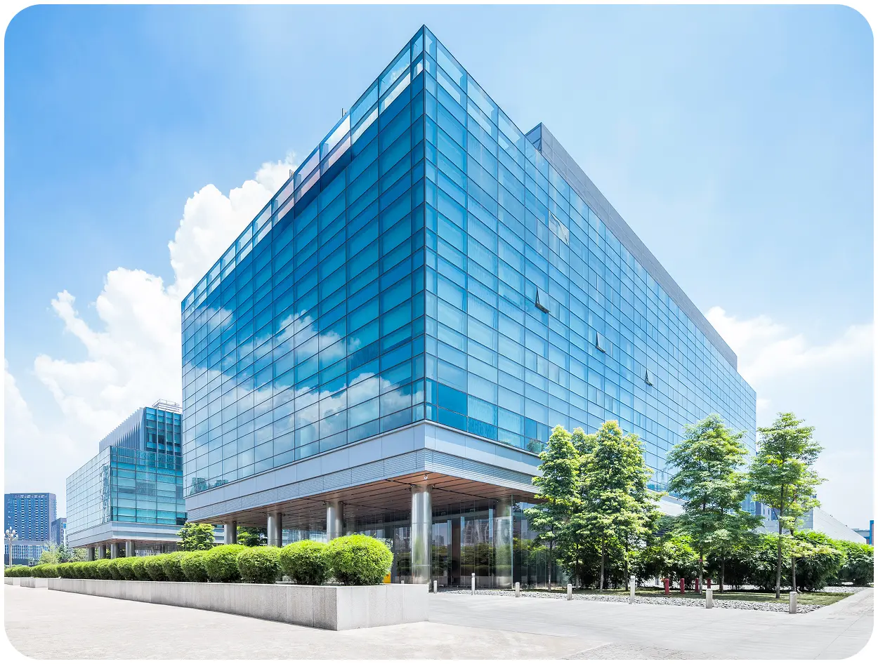Modern glass building under clear blue sky.